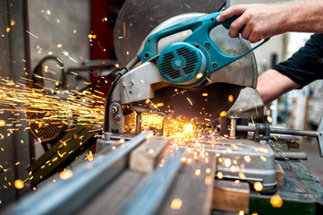 industrial worker using a  compound mitre saw