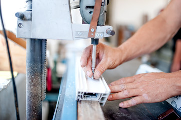 worker and handyman using an industrial tool for screwing