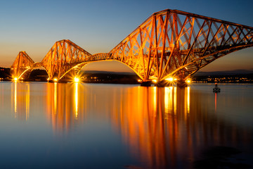 The Forth Rail bridge illuminated at dawn