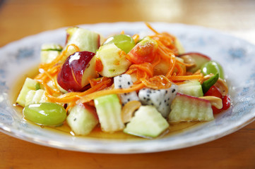 close up mixed fruit salad in dish