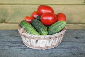 fresh cucumbers and tomatoes in a basket