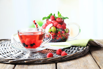 Fruit red tea with wild berries in glass cup,