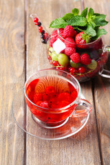 Fruit red tea with wild berries in glass cup,