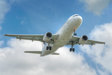 Fototapeta na wymiar big jet plane taking off on blue cloudy sky nackground