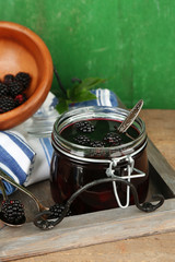 Fototapeta premium Tasty blackberry jam and fresh berries, on wooden table