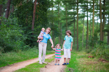 Fototapeta na wymiar Family hiking in a pine wood