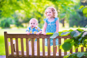 Fototapeta premium Two kids on a park bench