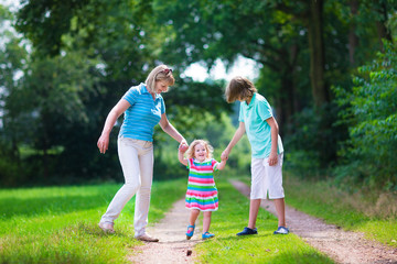 Family hiking in a pine wood