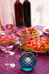 Buffet table with dishware and candles waiting for guests