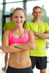 smiling man and woman in gym