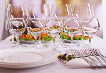 Buffet table with dishware waiting for guests