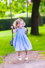 Little girl on a swing