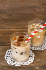 Iced coffee with milky ice cubes and cold milk with coffee ice