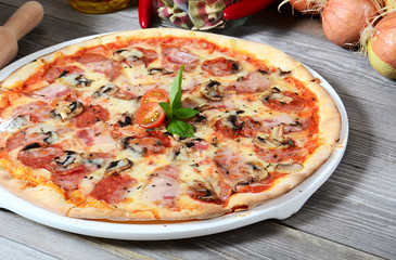 The Italian pizza with olives and a salami