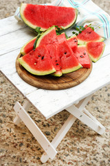 Fresh slices of watermelon on table, outdoors