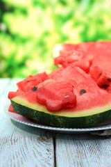 Fresh slices of watermelon on table, outdoors