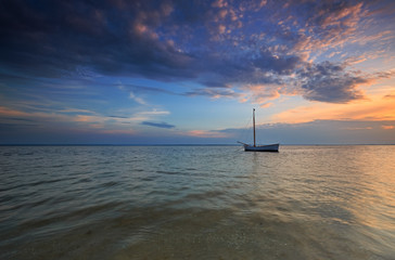 Lonely boat at sea at dusk