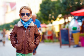 stylish kid walking city street, autumn fashion © Olesia Bilkei