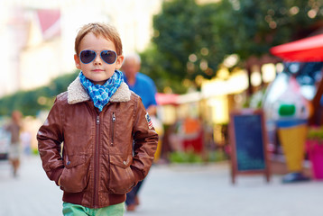 stylish kid walking city street, autumn fashion
