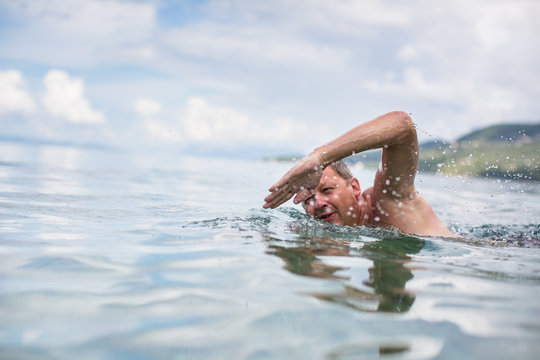 Senior man swimming in the Sea/Ocean