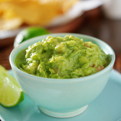 guacamole in colorful blue bowl with tortilla chips