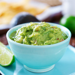 guacamole in colorful blue bowl with tortilla chips