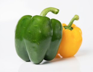 yellow and green sweet peppers on white background.