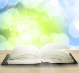 Open book in front of abstract background