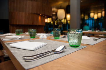 Glasses and plates on table in restaurant