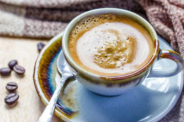 Cup of espresso with coffee beans