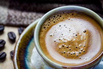 Cup of espresso with coffee beans