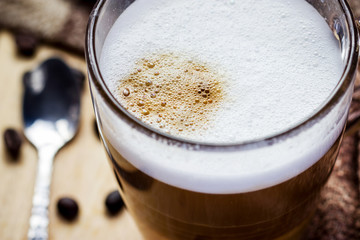 glass of cappuccino coffee on wooden