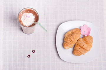 two croissant and one coffee at breakfast