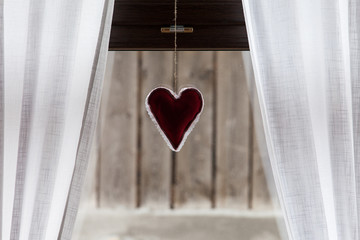 heart on the window with curtain