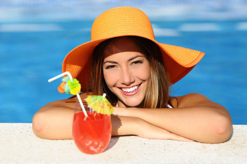Beauty woman with perfect smile in a swimming pool on vacations