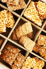 tasty sweets (kozinaki)in wooden crate, close up