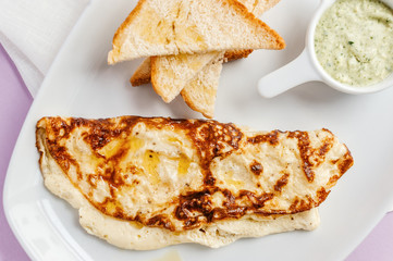Omelette with toastes and green sauce