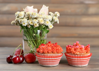 Tasty cupcakes on wooden table, close up