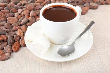 Cup of hot chocolate on table, close up