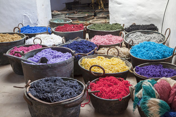 Pots with colorful yarns dyed in the old workshop - obrazy, fototapety, plakaty
