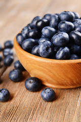 Delicious blueberries in bowl on table close-up
