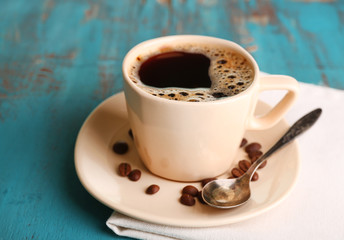 Cup of coffee on color wooden background