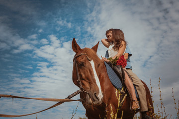 Young beautiful couple  with a horse. Filtered. Selective focus.