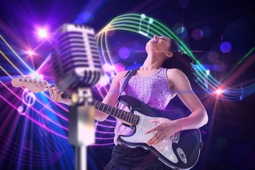 Obraz na płótnie Canvas Composite image of pretty girl playing guitar