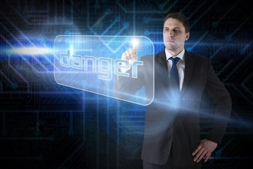 Businessman pointing to word danger
