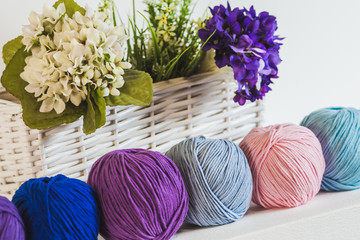 Collection of colorful balls of woolen yarn on the shelf