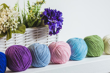Collection of colorful balls of woolen yarn on the shelf