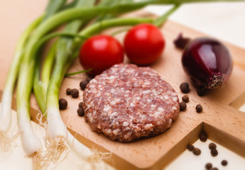 raw meatball on a chopping board and ingredients. horizontal. cl