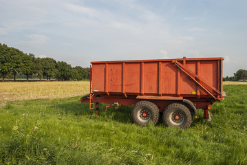 Red trailer on field