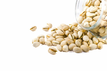 Pistachio nuts in glass bowl isolated